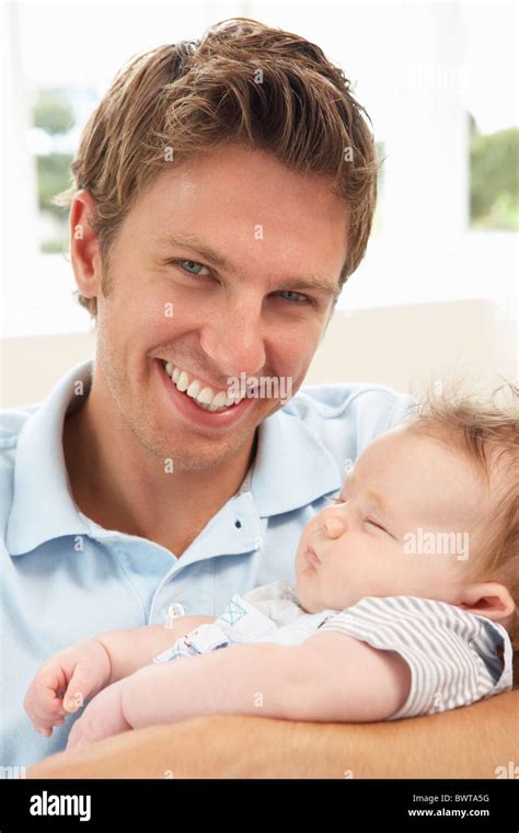 Close Up Of Father Cuddling Newborn Baby Babe At Home Stock Photo Alamy
