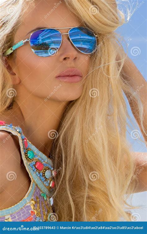portrait beauty stunning blonde model with perfect face wearing a sunglasses and elegant white