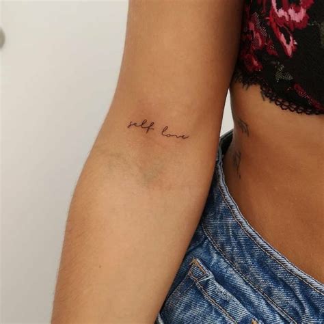 A Woman S Arm With The Word Love Tattooed On Her Left Side Ribcage