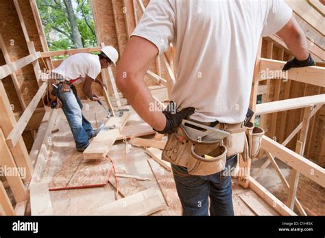 Carpenters working at a construction site Stock Photo - Alamy