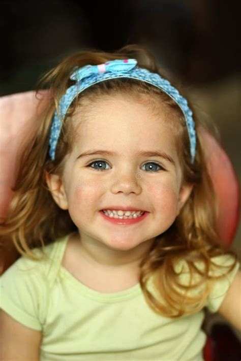 Close Up Portrait Of A Girl With A Very Toothy Smile Stock Photo
