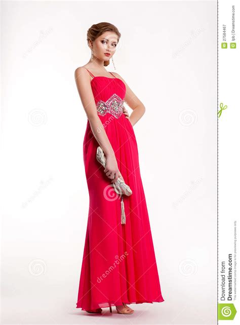 Trendy Fashion Model In Long Red Dress Posing Stock Image