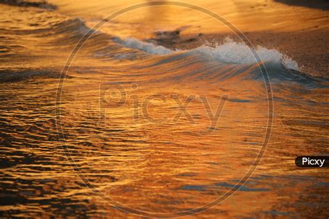 Image Of Waves Of A Sea Ocean With Gold Luminous Colour Of Sun