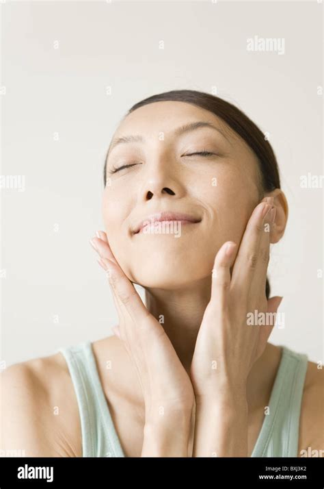 A Woman Touching Her Cheek Stock Photo Alamy