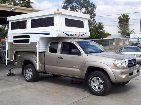 A Truck With A Camper Attached To The Bed