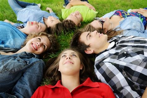 Premium Photo Group Of Friends Lying On Meadow