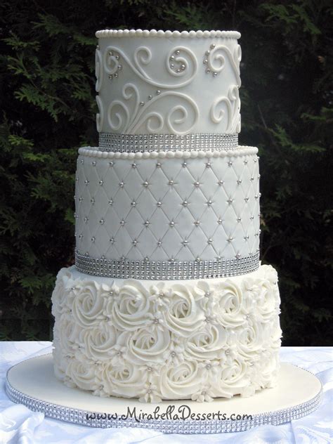 3 Tier All White Wedding Cake Decorated With Buttercream Rosettes Quilting And Scrolli