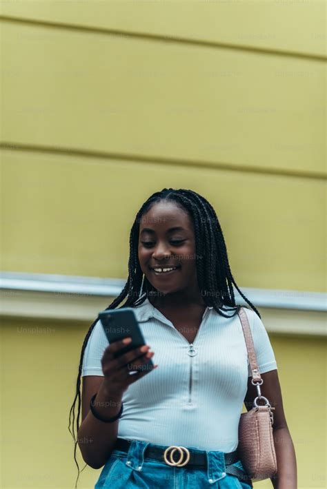 beautiful african american woman using smartphone while out in city photo mobile phone image