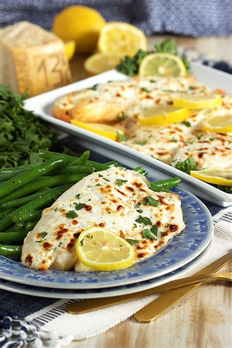 Brushing the fish with a garlic butter mixture and sprinkling with parmesan cheese gives these tilapia filets a delightful crust and loads of flavor. Flaky Parmesan Tilapia Recipe - The Suburban Soapbox