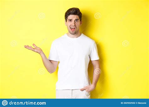 Confused And Shocked Man Complaining Raising One Hand And Looking