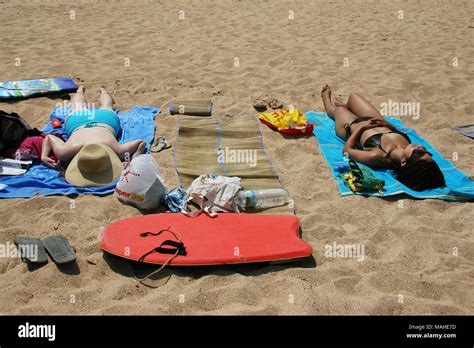 Two European Women Sunbathing On Beach In Bikinis Stock Photo Alamy