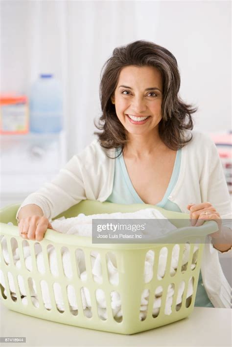 Hispanic Woman Doing Laundry Photo Getty Images