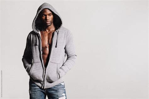 Thoughtful Man In Hooded Sweatshirt With Bare Chest By Stocksy