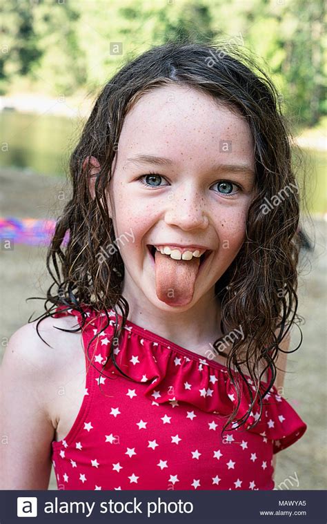 Download This Stock Image A Young Girl Sticking Her Tongue Out 7 9
