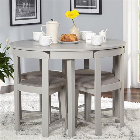 A standard height dining room table is a classic for good reason. Five-Piece Compact Round Dining Set | Space saving dining ...