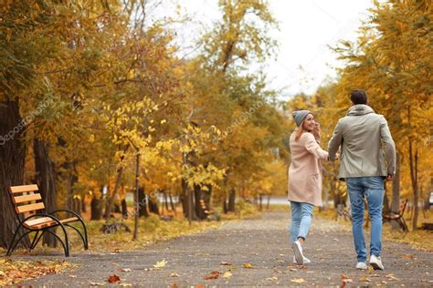 Young Couple Walking Park Autumn Day — Stock Photo © Belchonock 175674152