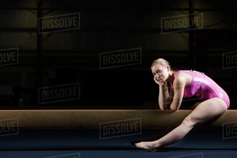 Female Gymnast Sitting On Balance Beam Stock Photo Dissolve