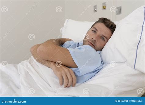 Young Patient Man Lying At Hospital Bed Resting Tired Looking Sad And