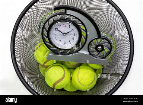 Tennis Balls And A Clock In A Trash Can Stock Photo Alamy