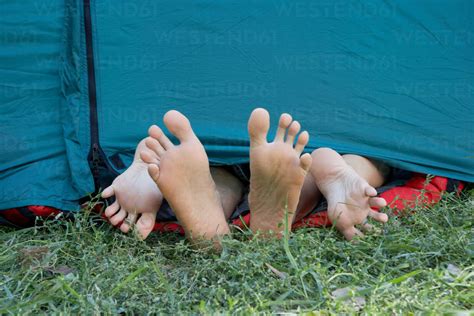 Two People S Feet Sticking Out Of Tent Stock Photo