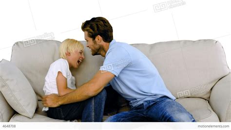 Father Tickling His Son On The Sofa On White Backg Stock Video Footage