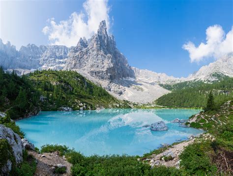Hiked Over A Mountain Pass To A Blue Lake Under Blue Skies In Italy