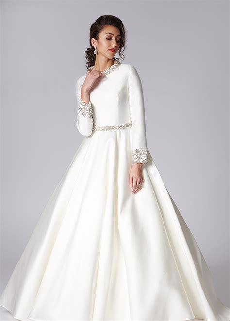 We may earn commission on some of the items you choose to buy. Elegant yet modest ivory mikado satin ballgown with ...