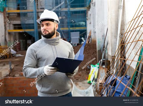 Confident Young Supervisor Inspecting Process Building Stock Photo