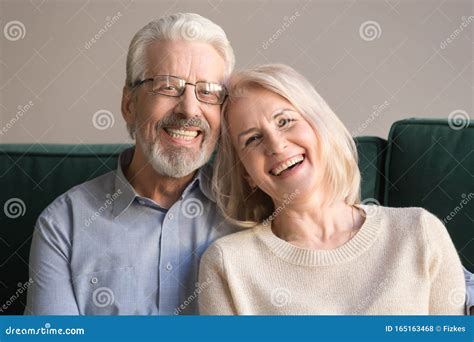 Head Shot Portrait Of Laughing Elderly Attractive Couple Stock Photo