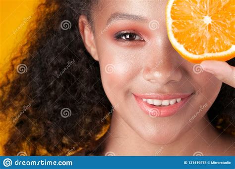 Young Smiling Black Girl With Clean Perfect Skin With Orange Close Up