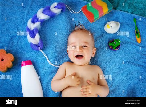 Baby Lying On Towel With Washing Tools Stock Photo Alamy