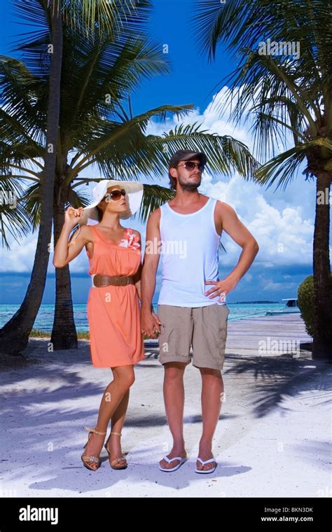 Romantic Couple Standing Next To Palm Tree Stock Photo Alamy