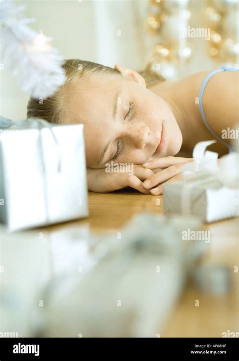 Girl Lying On Floor Next To Christmas Tree Stock Photo Alamy