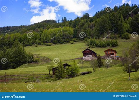 Idyllic Landscape In The Alps In Springtime With Traditional Mountain