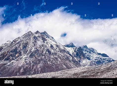 Snow Cap Mountains With Bright Blue Sky At Morning From Flat Angle