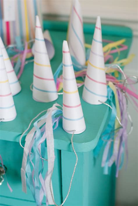 A party hat is generally a playful conical hat made with a rolled up piece of thin cardboard, usually with designs printed on the outside and a long string of elastic acting like a chinstrap, going from one side of the cone's bottom to another to secure the cone to the person's head. Go Ask Mum 12 Magical Unicorn Party Ideas That Will Blow ...