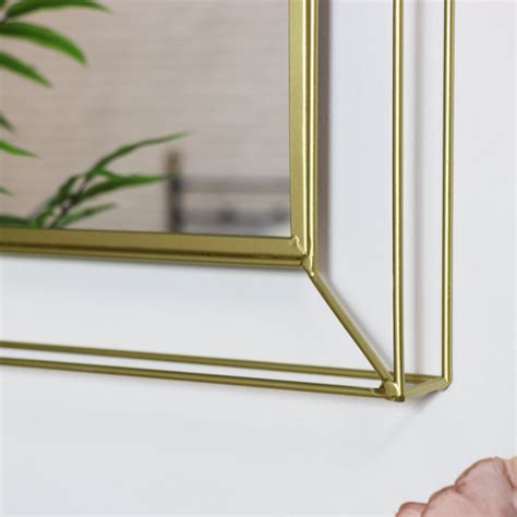 A large wall mirror is perfect for checking how you look on the way out of the house whilst also reflecting light throughout your home. Small Metal Gold Framed Wall Mirror - Windsor Browne