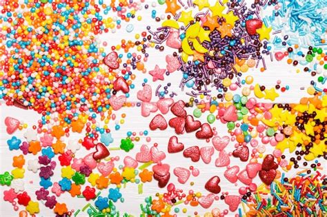 Premium Photo Various Color Sprinkles Scattered On White Wooden Table