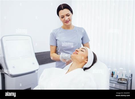 Portrait Of Relaxed Young Female Client Getting Smas Ultrasound Face