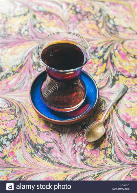 Turkish Tea In Traditional Oriental Tulip Glass Over Colorful
