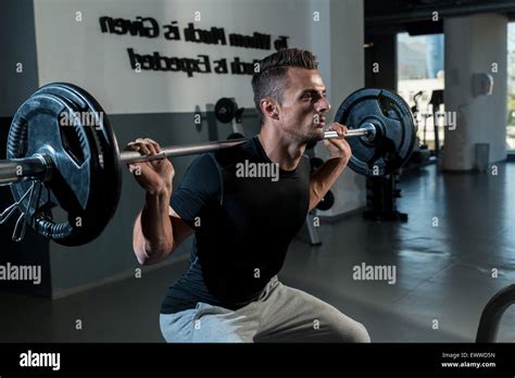 Fitness Trainer Doing Squats With Barbells Stock Photo Alamy