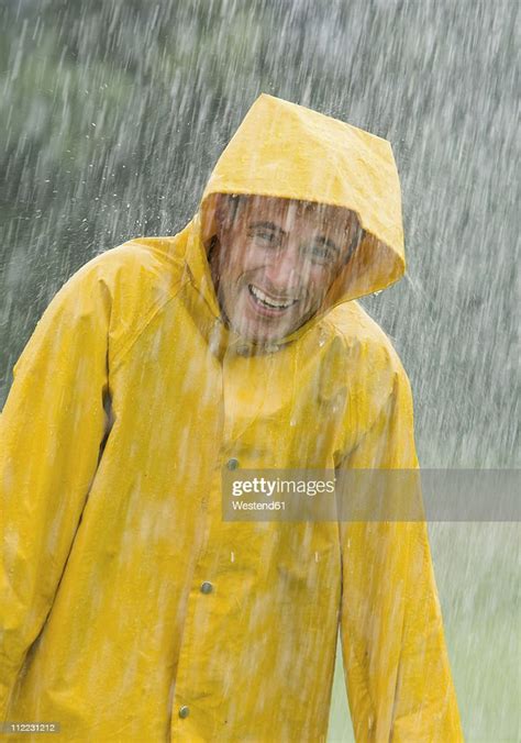 Man Wearing Rain Coat Standing In Rain Portrait Photo Getty Images
