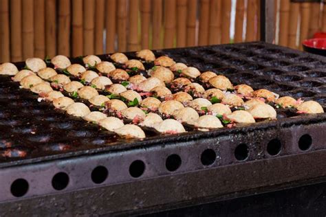 Japanese Street Food Takoyaki At Special Grill Pan Process Of Cooking Takoyaki Balls With