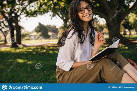 escritura de la mujer en un libro en el parque foto de archivo imagen de césped sentada