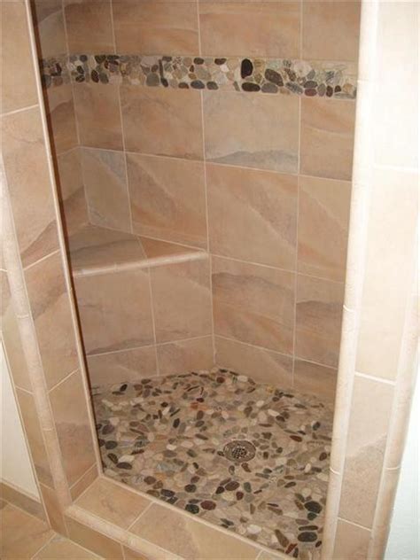 A clean pebble shower floor welcomes you with sanitary, smooth, nubby stones to massage tired, achy feet. river stone shower floor and accent | Home Ideas | Pinterest