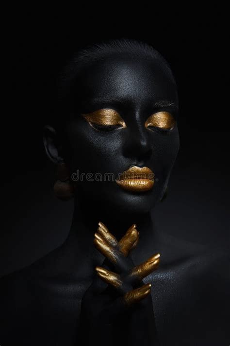 Beauty Woman Painted In Black Skin Color Body Art Gold Makeup Lips Eyelids Fingertips Nails In