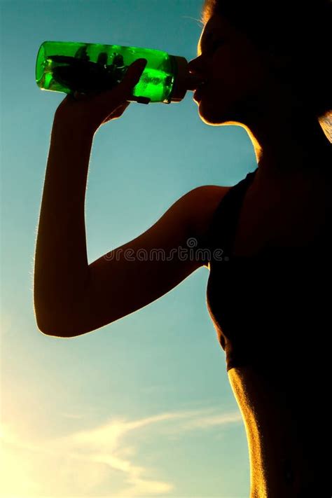 Beautiful Young Girl Is Drinking Water On Sports Training Stock Photo