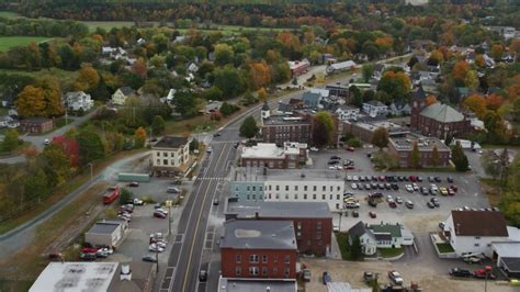 6k Aerial Video Flying Over Central Street Through Small Town