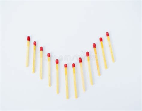 Match Sticks Arranged In A Arrow Shape On An White Background Stock