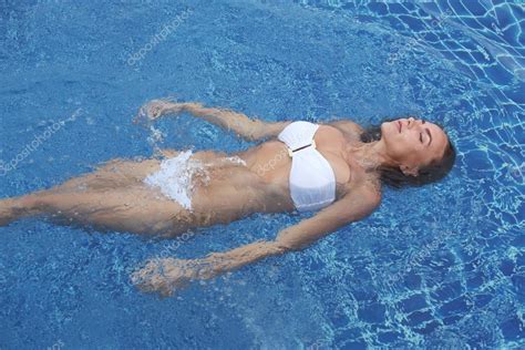 Woman Floating In Pool Stock Photo By Yellow2j 97708402